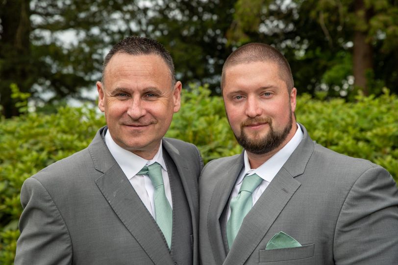 Rob Montgomery standing beside his son on his son's wedding day.