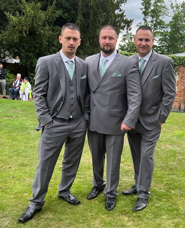 Rob Montgomery with his two sons at his son's wedding.